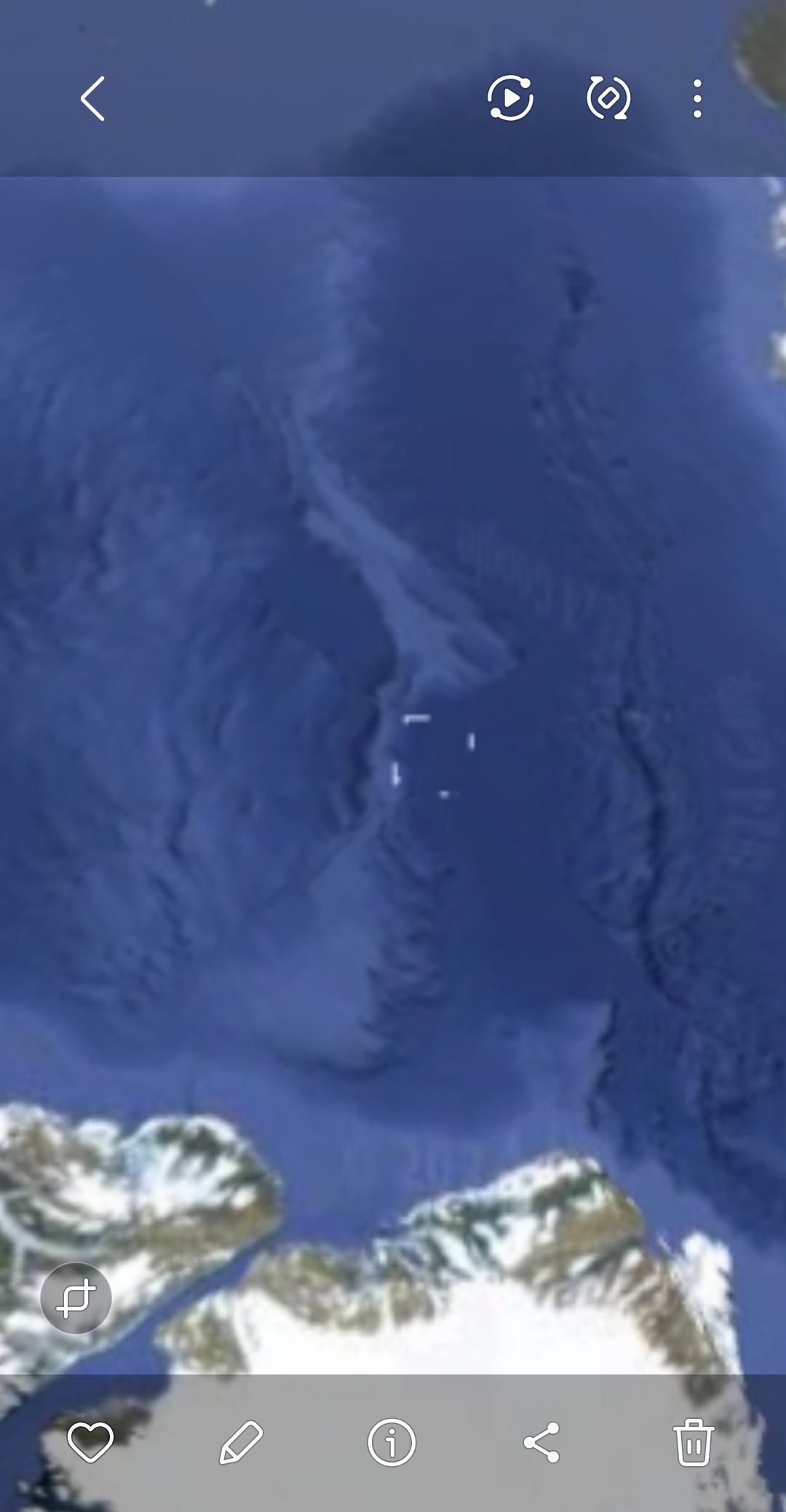 Satellite gallery view of the Greenland fjord coast showing four discrete bright marker dots arranged in the central ocean channel between rocky coastline edges marking the original four pulsing dots that the Perceiver previously documented at this coordinate and which now appear as the origin points of the transparent shooting line geometry