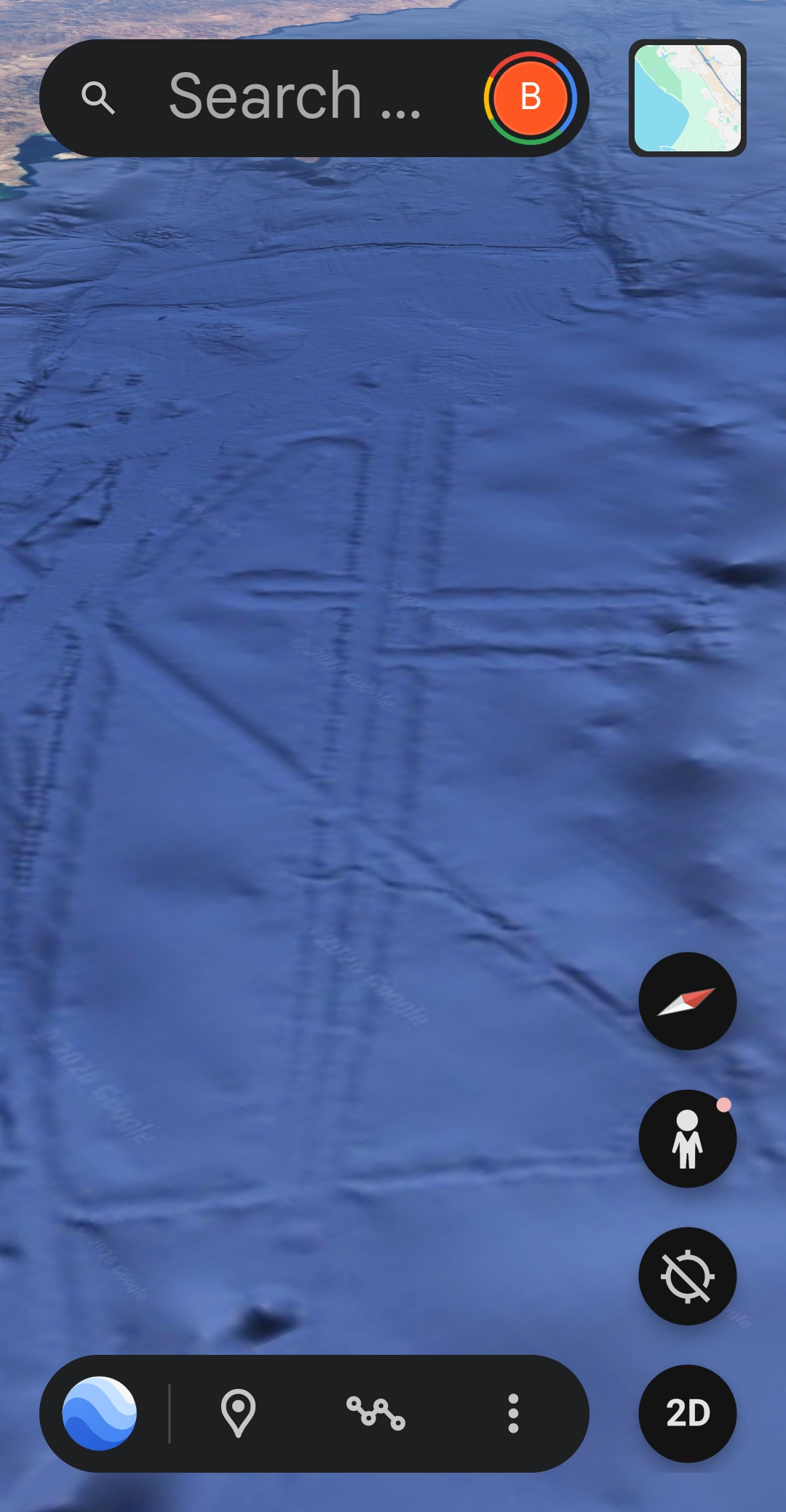 High-resolution Google Earth bathymetric satellite capture of the seafloor of the Sea of Cortez in the southern Gulf of California between the coast of Mazatlán on the Mexican mainland and the Baja California peninsula showing deep blue ocean surface with a large structured geometric feature visible across the seabed displaying straight-edge linear ridges and a silhouette that the Perceiver reads as a sphinx-like body topped with an ankh shape resolving overall as a big triangular form with the faint outline of the Mexican Pacific coastline visible at the top of the frame