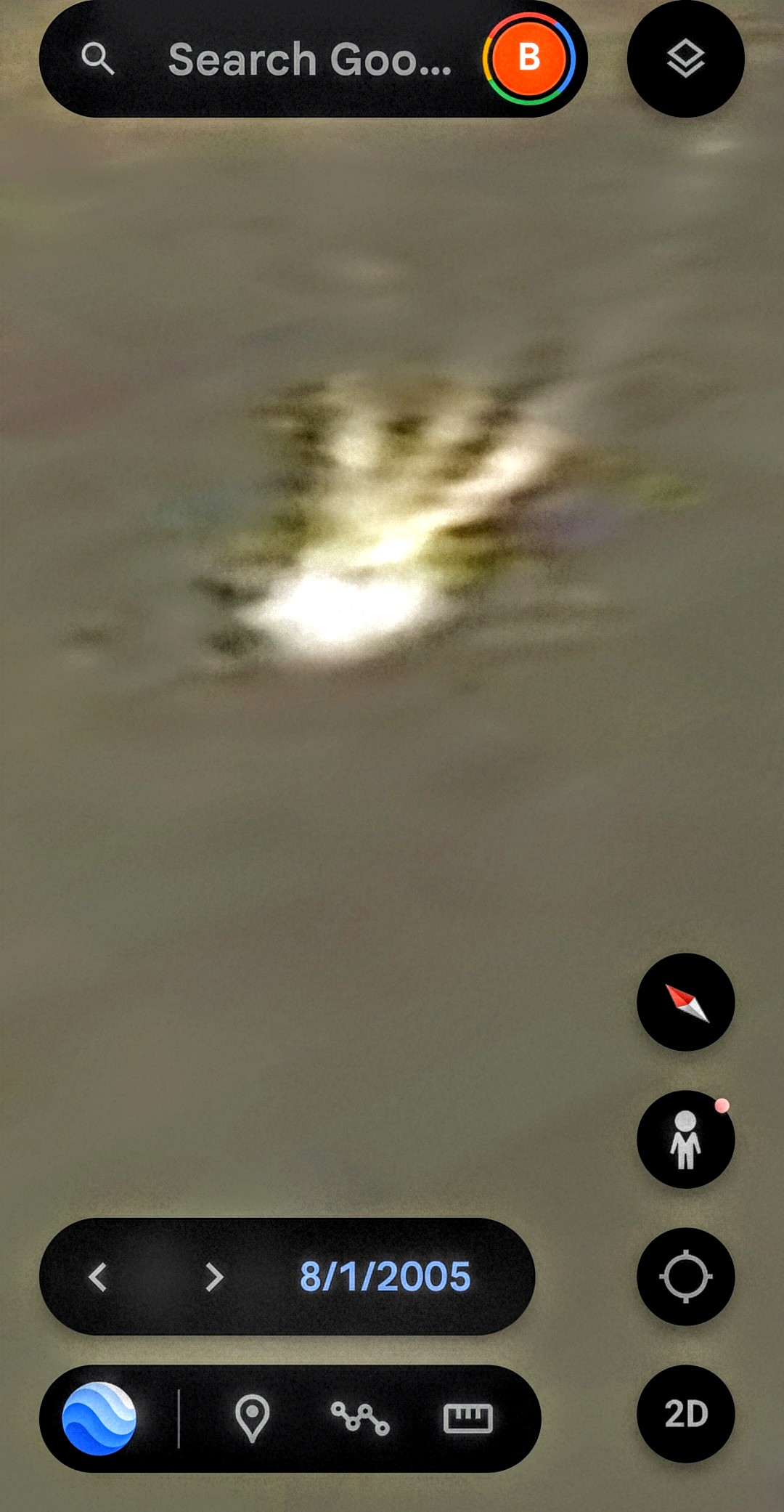 Google Earth historical imagery dated August 1 2005 lateral vantage showing the same luminous signature from a side angle the reflective glint carries a trailing wake or shadow pattern aligned to the long axis of the body consistent with a discrete underwater signature on or just beneath the river surface rather than a compositing artifact