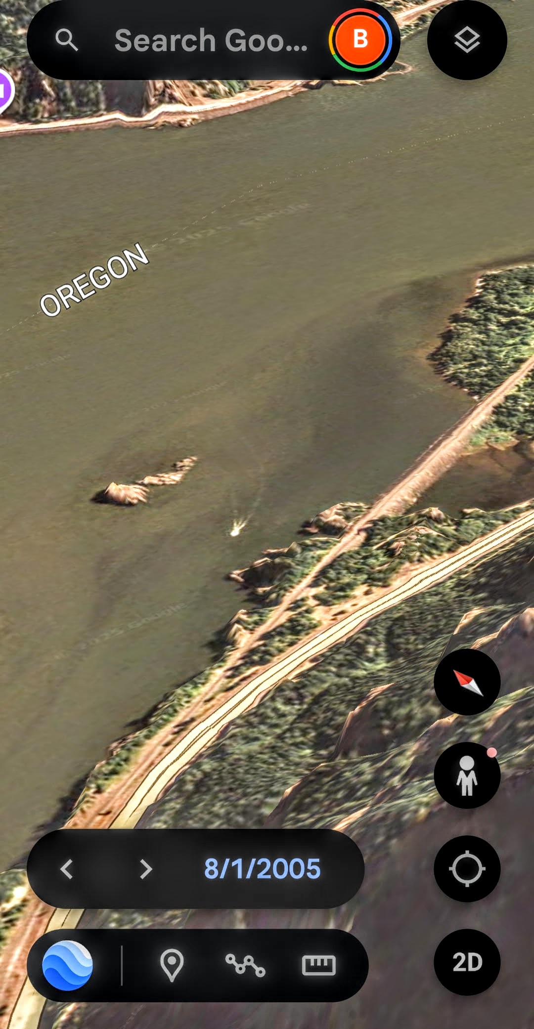 Google Earth historical imagery dated August 1 2005 wide context vantage with Oregon state label visible showing the luminous signature in proper geographic position on the Columbia River with adjacent shoreline highway and bridge infrastructure providing scale reference for the discrete underwater body