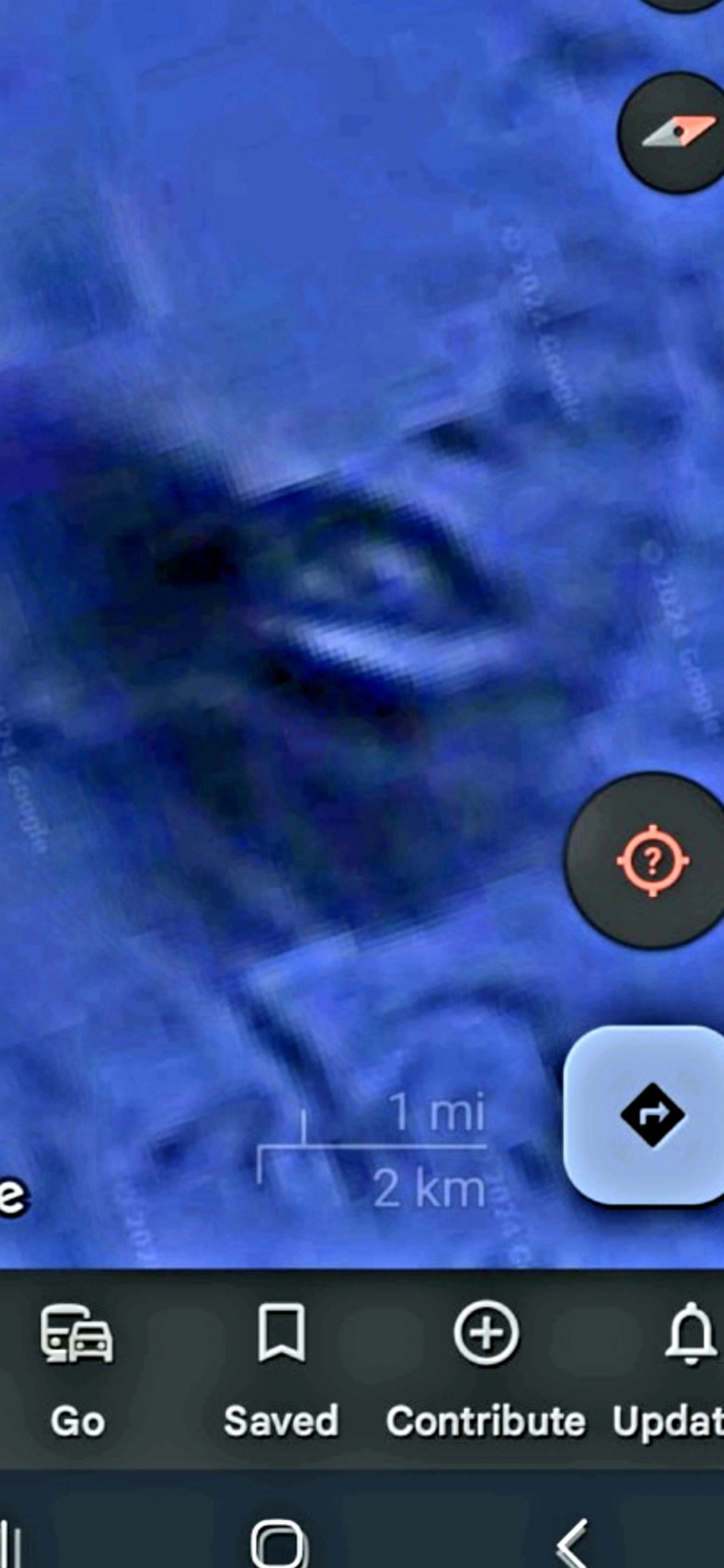 Google Maps satellite capture in incognito mode of the Pacific seafloor in the Mazatlán under-the-ocean Pacific Coast corridor rendered in saturated blue tones with the Google Maps bottom navigation bar showing Go Saved Contribute and Update icons visible at the bottom of the frame along with the 1 mile 2 kilometer scale bar resolving into a discernible facial geometry that the Perceiver classifies as a first aquiferian face location of interest