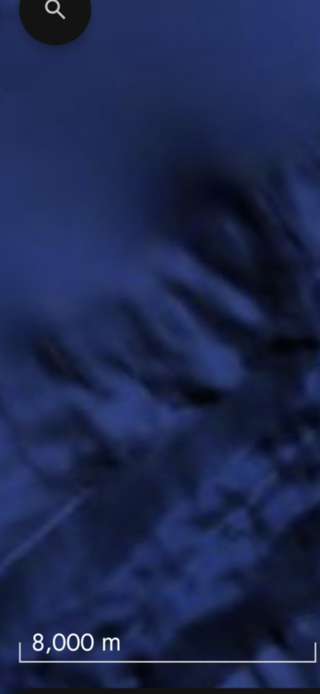 Closer zoom on the second aquiferian face in the Mazatlán Pacific Coast underwater archive with the search magnifying glass icon visible at the upper-left of the Google Maps interface showing the same different facial geometry at higher detail