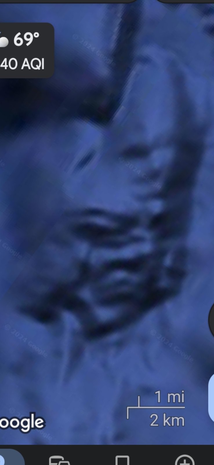 Deep underwater capture in the Mazatlán Pacific corridor showing what reads as a large humanoid or aquatic life-form silhouette rendered in cyan and dark blue with discernible head torso and limb-like extensions visible against the surrounding sea floor camouflage with weather overlay showing 69 degrees and 40 AQI