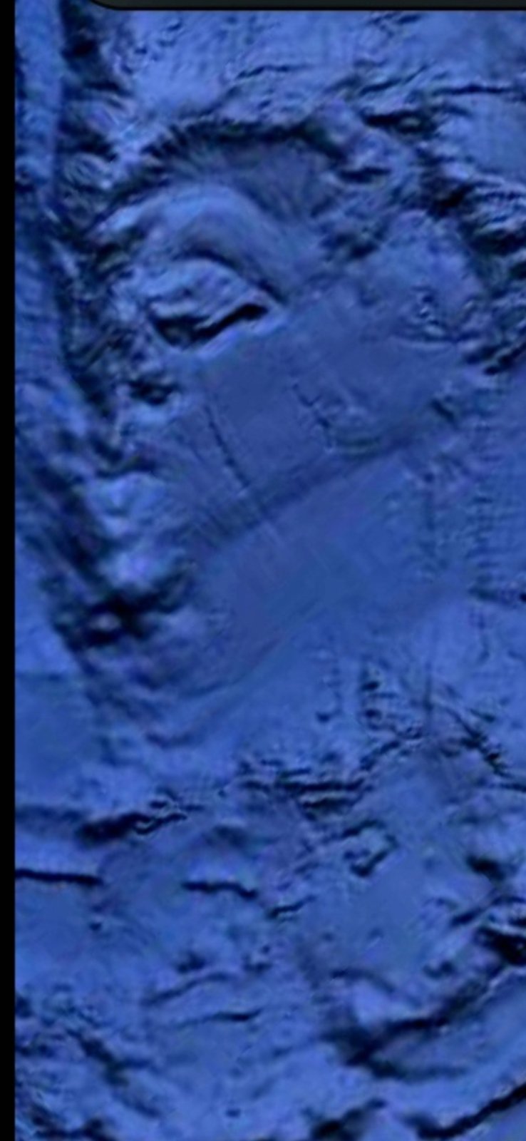 Pacific seafloor close-up near Mazatlán showing a distinct rectangular geometric formation embedded in the seabed with sharp linear edges defining the structure and surrounding zones of eroded or churned material consistent with installation rather than natural geology