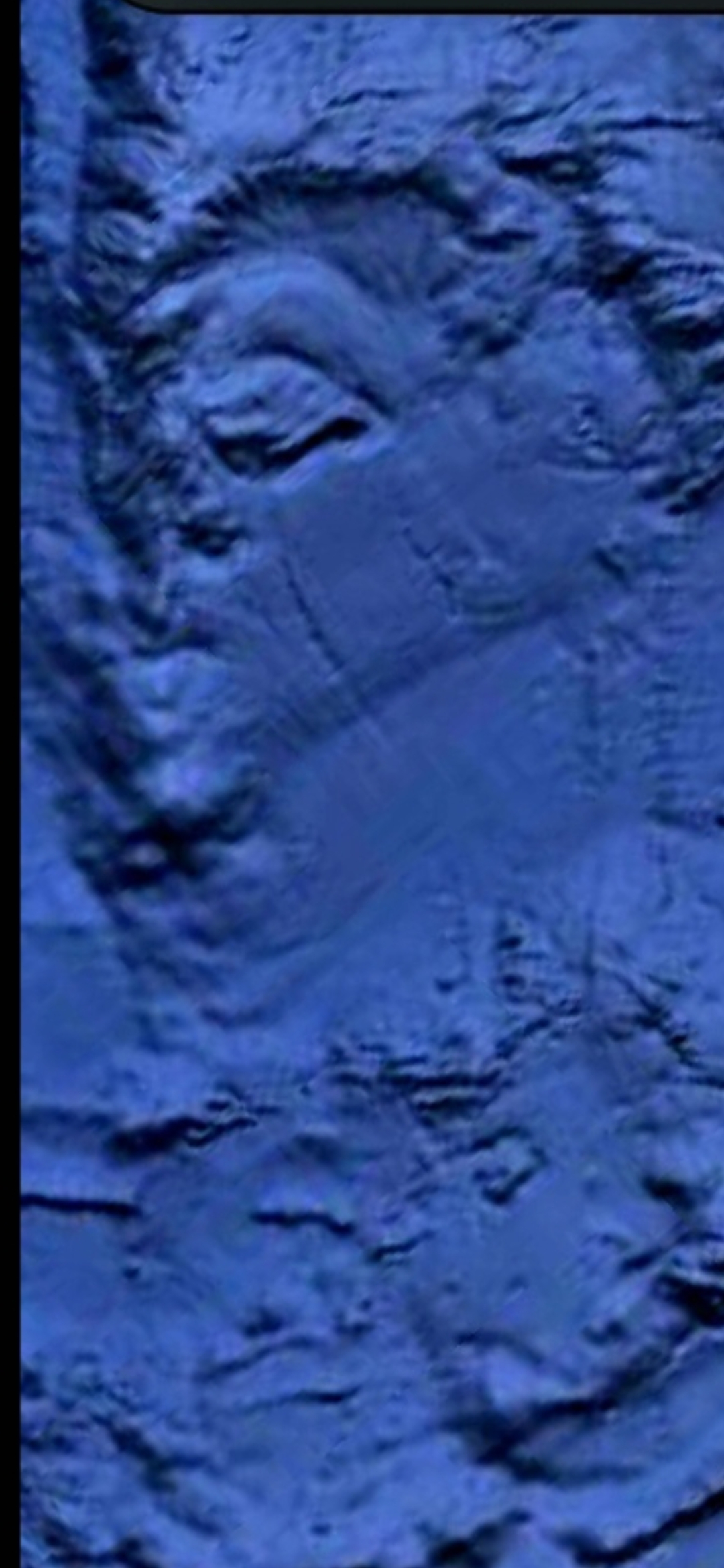 Bathymetric seafloor capture showing complex underwater terrain with ridges depressions and irregular crevasse-like channels rendered in deep blue tones consistent with subsea canyon or fissure topography in the Mazatlán Pacific corridor that the Perceiver flags as a candidate aquatic life-form habitat zone