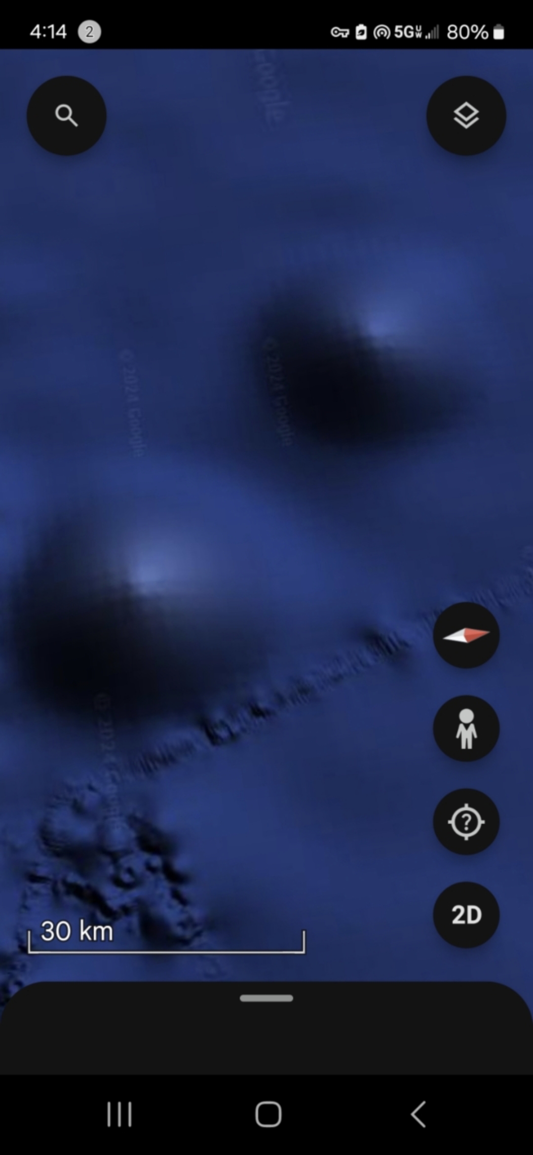 Two large softly glowing circular or elliptical zones rendered against a deep dark blue ocean background captured at 30 kilometer scale in the Mazatlán Pacific corridor with diffuse halos around each bright core suggesting non-reflective internal illumination rather than surface glint
