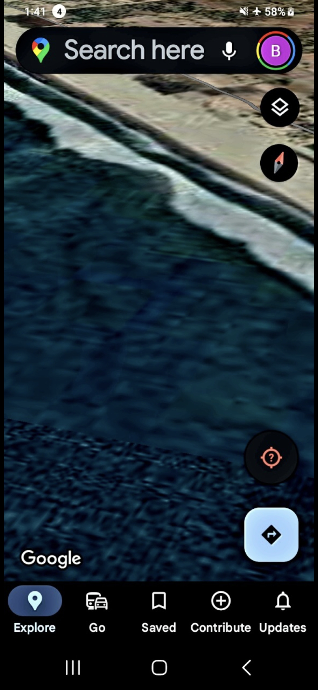 Aerial satellite view of the Stone Island Isla de la Piedra south surf zone in Mazatlan Bay showing the breaking wave line meeting the rocky shoreline with a parallel light and dark banding pattern in the shallow water immediately offshore documenting the threshold of the suspected reptilian base structure along the southern shoreline