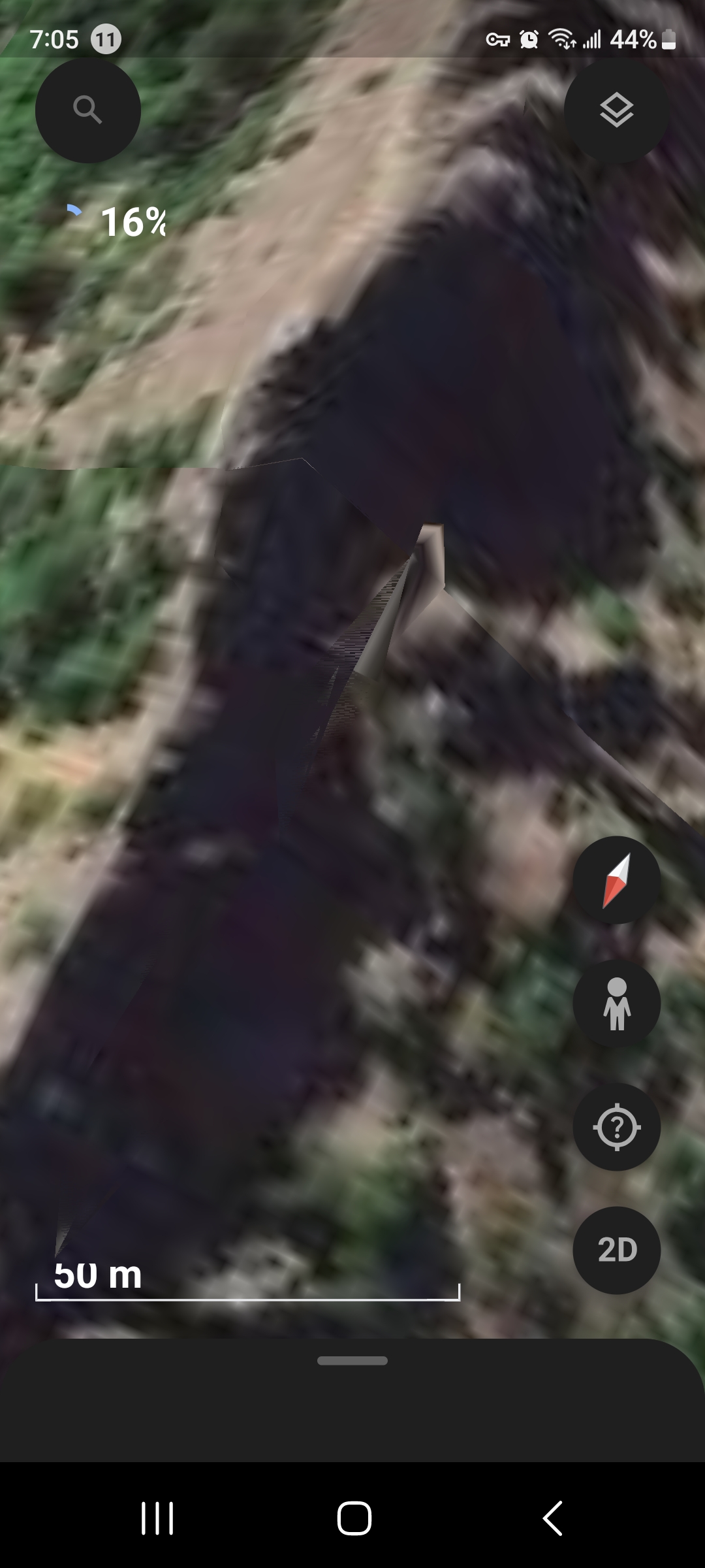 Smartphone Google Earth capture at 50 meter scale of the Mitchell Point Oregon coordinate showing a dark elongated parked craft silhouette extending diagonally across the rocky terrain