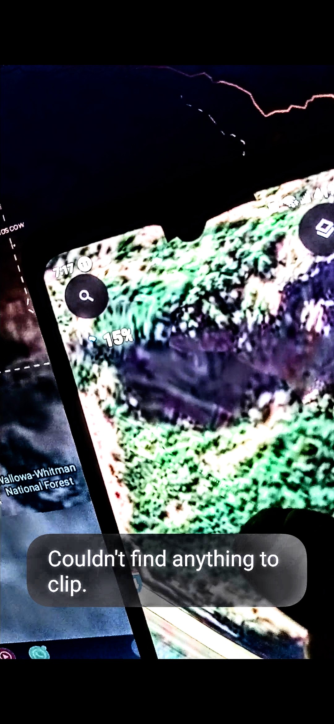 Infrared investigative photograph of Mitchell Point Oregon from the Perceiver showing the same coordinate captured in a Wallowa-Whitman National Forest map context with the rock-face geometry rendered in green and purple infrared hues revealing structural detail invisible in normal daylight imagery