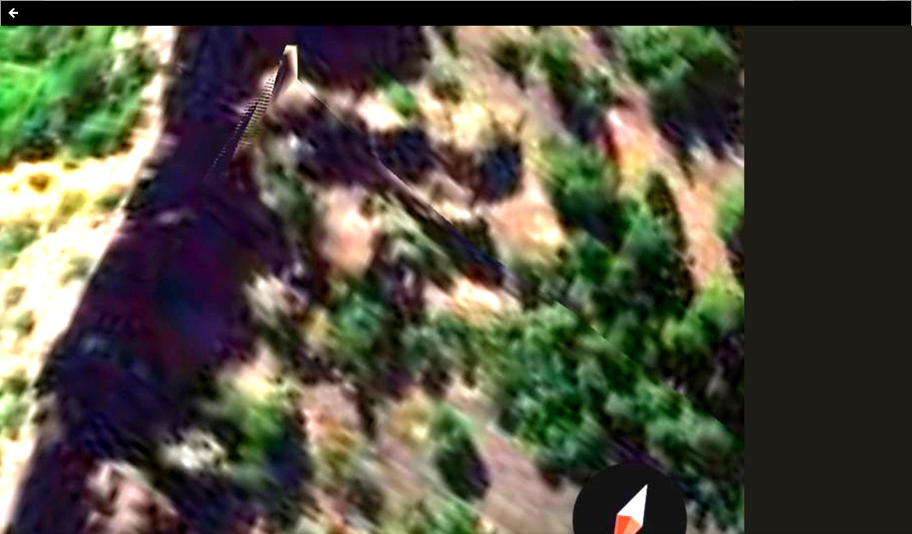 Aerial capture of Mitchell Point Oregon showing the dorsal top of the rock formation with a distinct crown or crest geometric structure visible that the Perceiver reads as the regalia or headpiece of the alien face geometry seated directly on top of the head