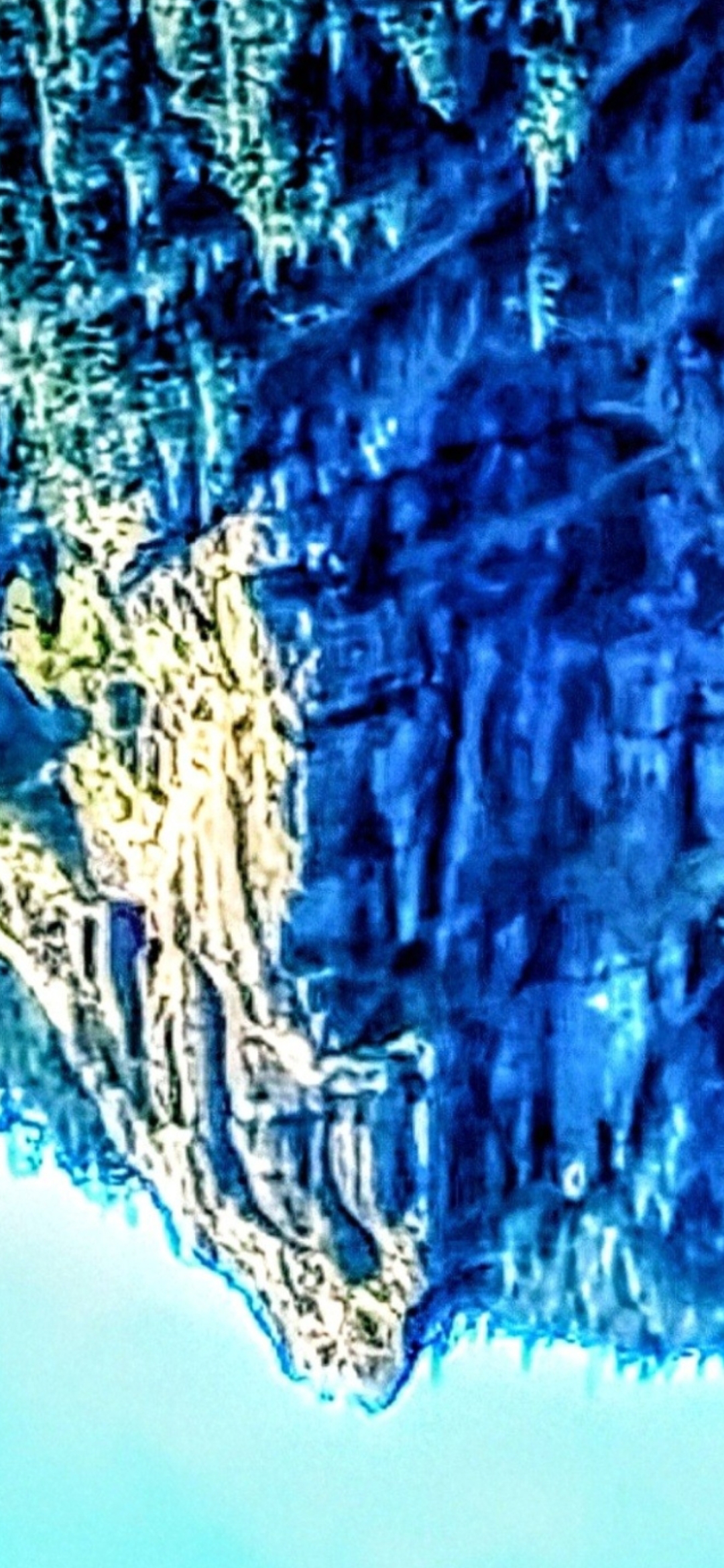 Closer zoom on the inverted Mitchell Point Oregon evil alien face with the predatory non-human physiognomy resolving with greater clarity in the rock geometry detail at the higher magnification confirming the geometric persistence of the evil alien reading across both the wide and zoomed inverted captures