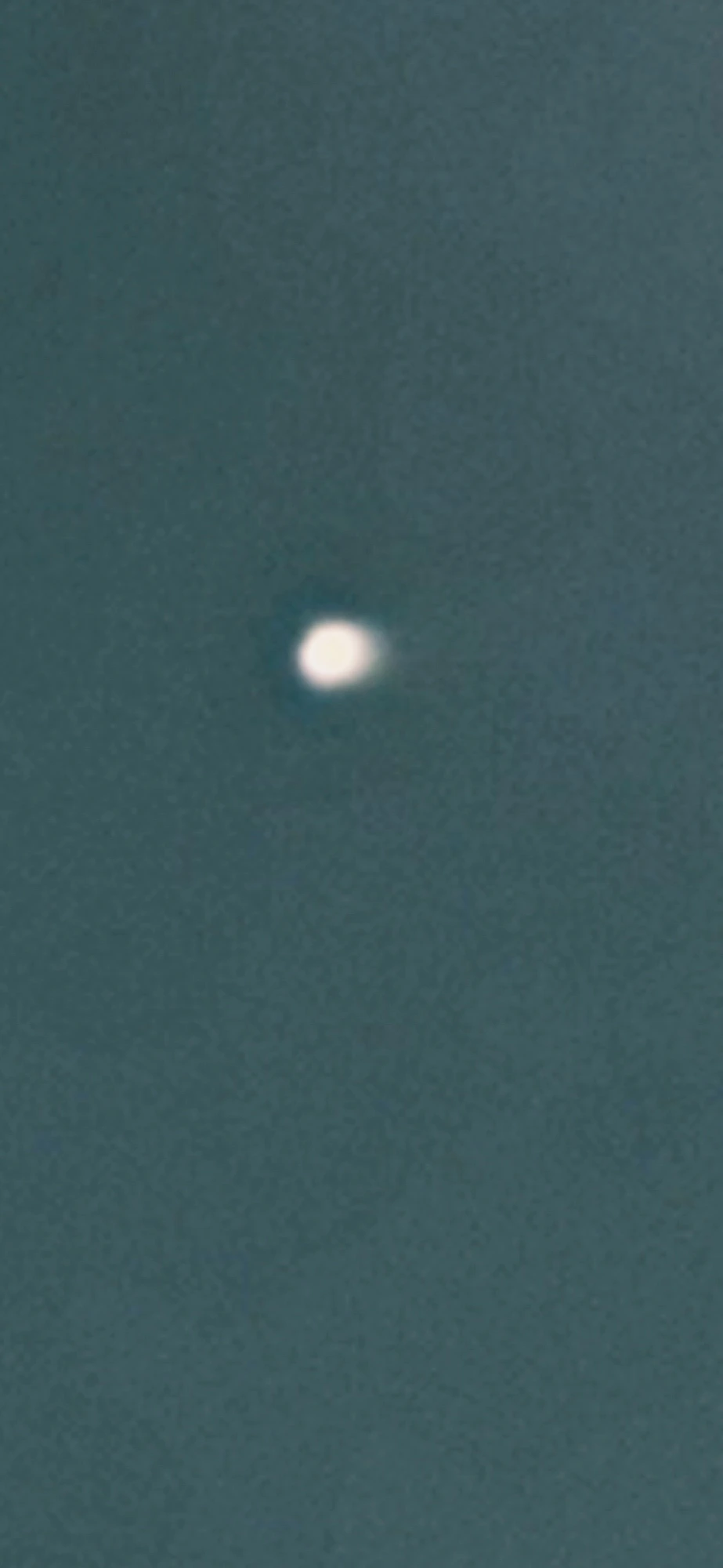 Extreme close-up zoom of the star-mimic object revealing a slightly elongated, non-pinpoint shape that is inconsistent with a distant stellar point source