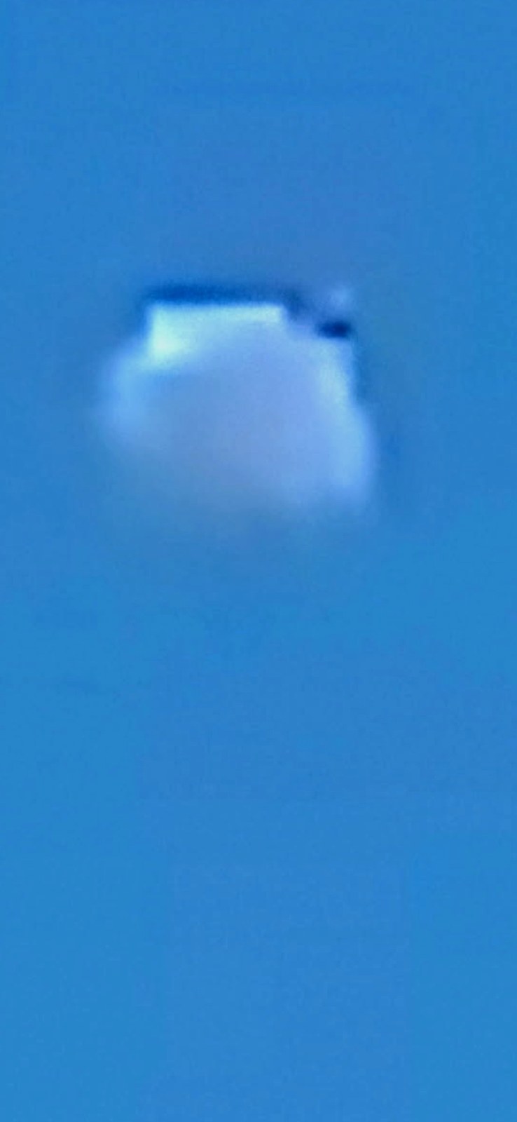 Extreme zoomed capture of what appears to be the moon along Highway 14 Columbia River Gorge revealing that it is actually a white square module inside a puffy cotton cloud formation with a distinct creature or entity visible next to the square structure confirming active camouflage technology and deception