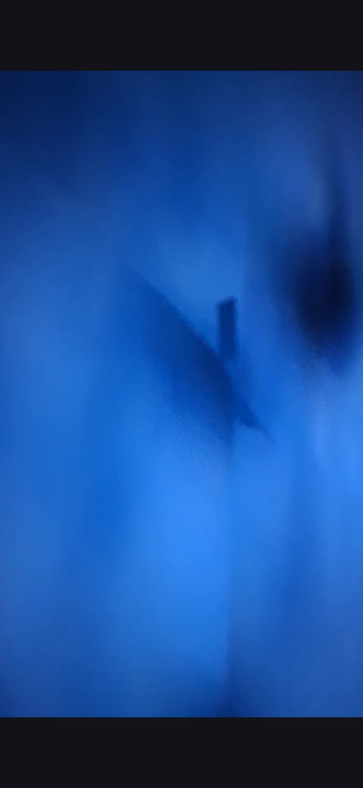 Pacific underwater installation showing an angular triangular outline with hooked edges suggesting a constructed geometric facility resting on the ocean floor beneath the camouflage layer