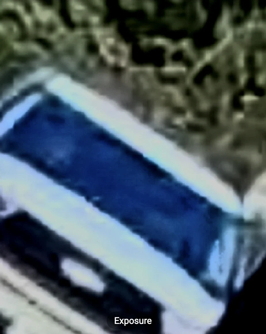 The foamy film on the blue car — dark-filter reveal (exposure −67)