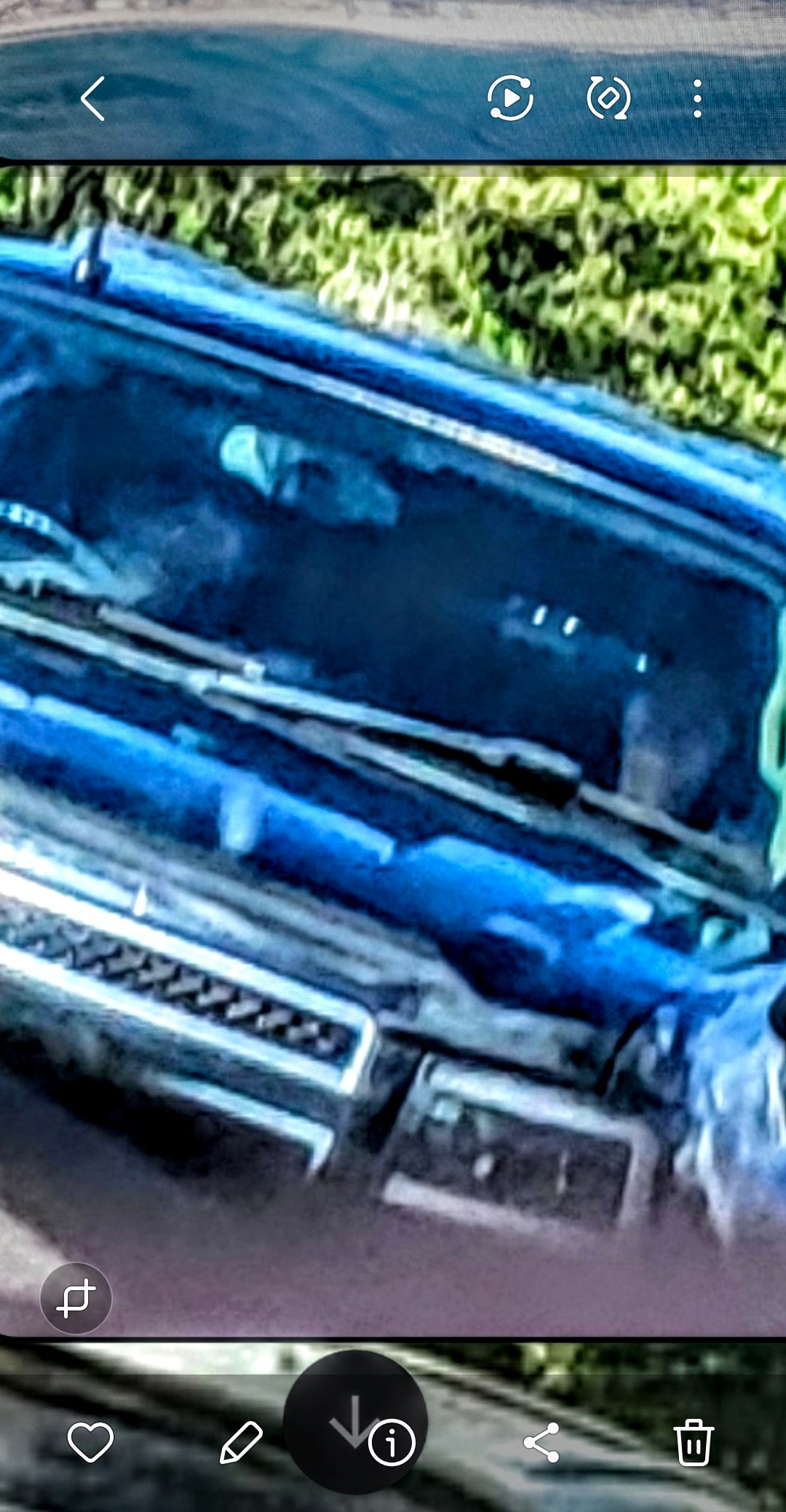 Clearer zoomed documentation of both the reptilian driver and the crustacean-armed companion entity inside the white Suburban
