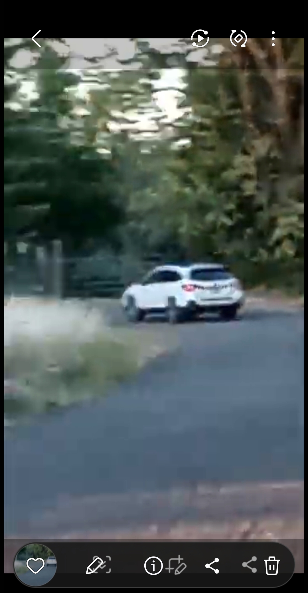 White Suburban vehicle containing reptilian entity and companion with crustacean features on road surveillance