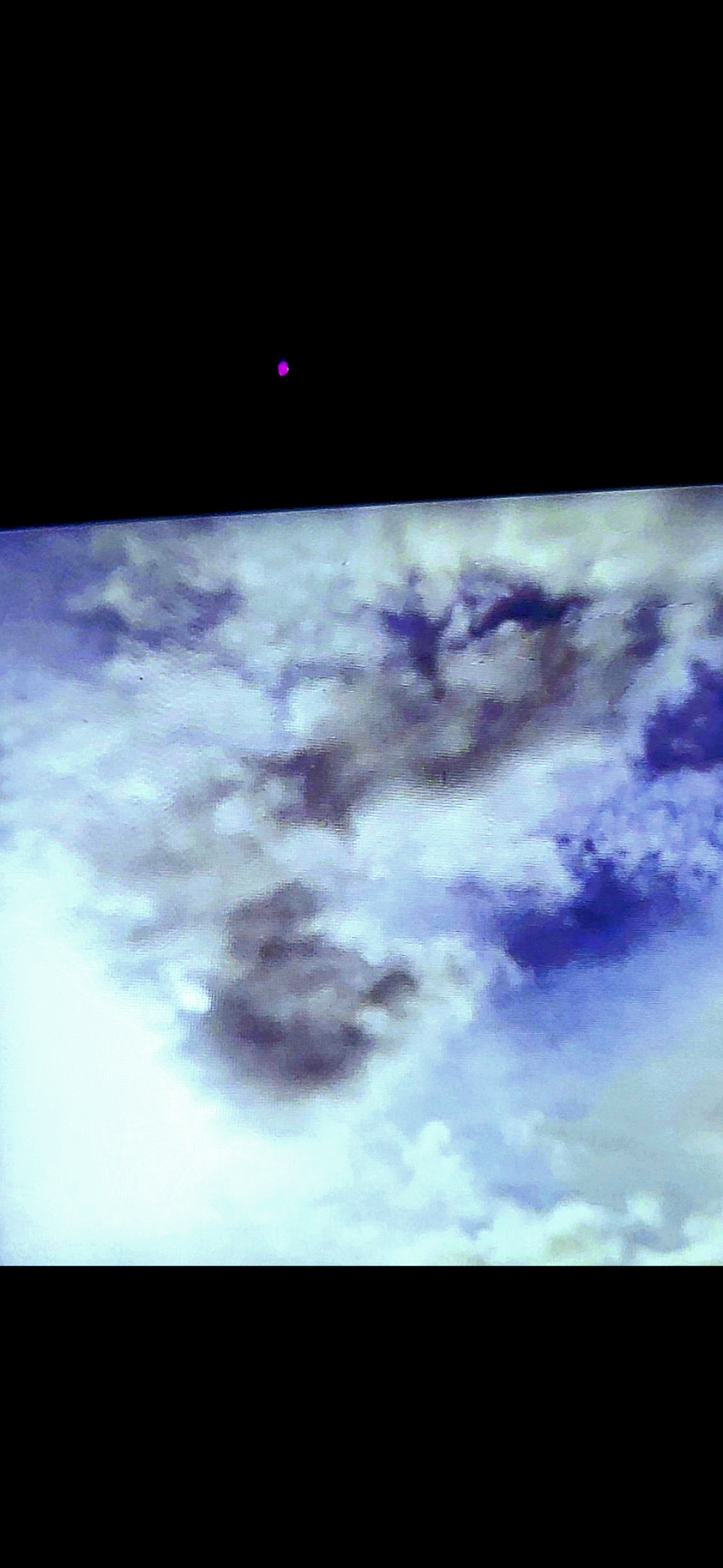Clearer darker filtered version of the female non-human watcher forming in the clouds above the Columbia River Gorge - face stands out prominently